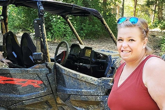 allison in front of offroad car