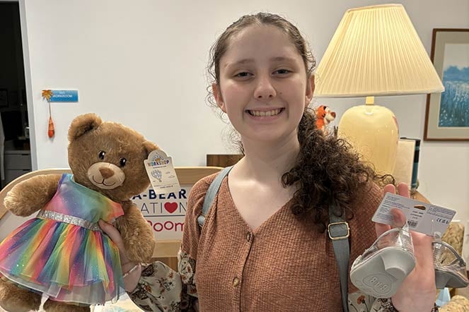 orthopedic patient Alysa holding teddy bear