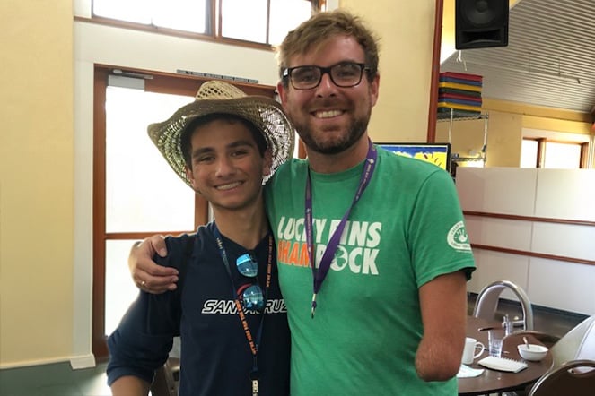 a teenager smiling with an amputee adult 