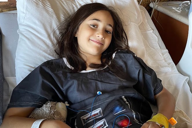 patient wearing a Darth Vader hospital gown smiling in a hospital bed