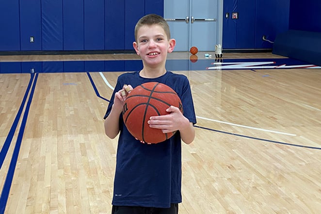 patient with basketball in basketball court