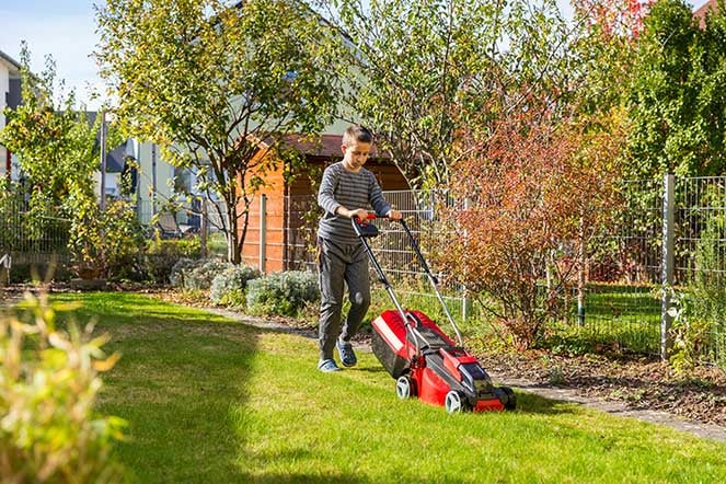 boy mowing the lawn