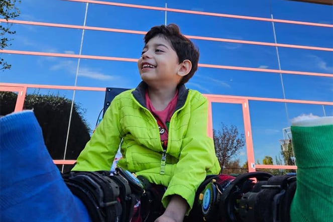 a child wild leg casts sitting on the ground