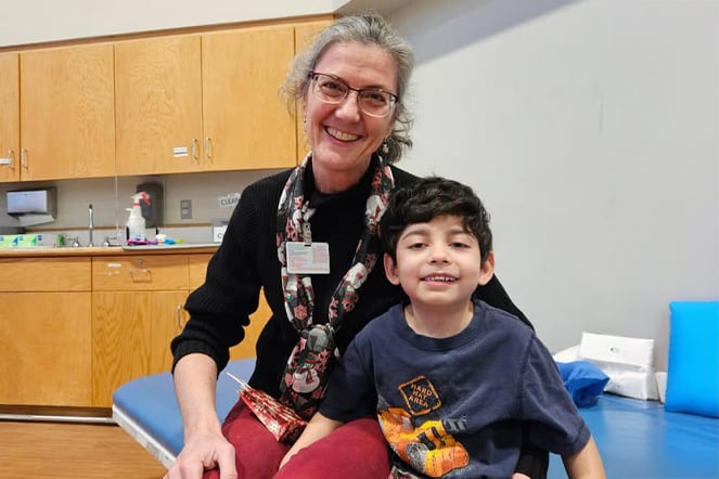 a woman and a child smiling in a doctor's office