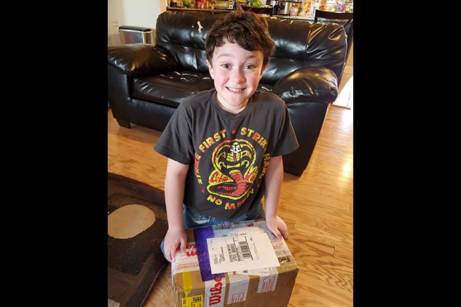 Charlie opening the box his glove arrived in