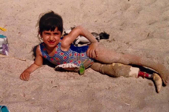 female child in sand at beach