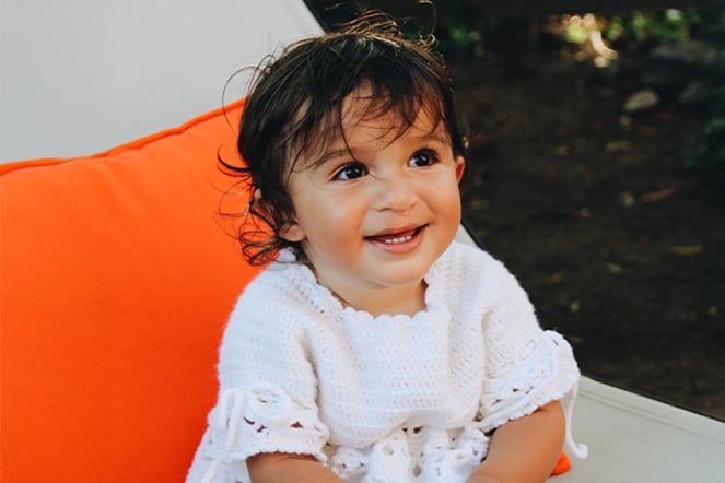 a toddler sitting in a lawn chair
