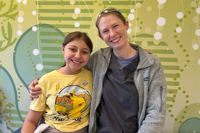 Angel and Lauren, her prosthetist, sitting and smiling together