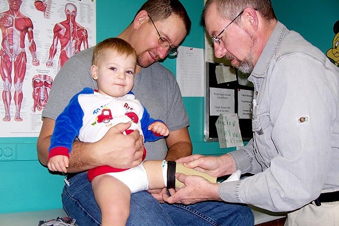 abby Colton with father and provider during prosthetic fitting
