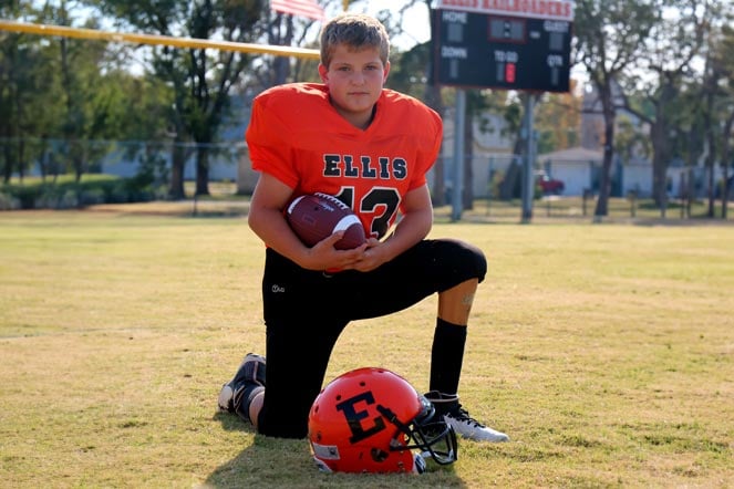 Colton wearing football uniform