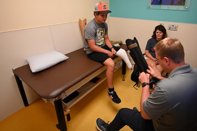 Colton, mom and provider during prosthetic fitting