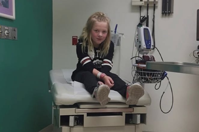 a young child sitting in an exam room