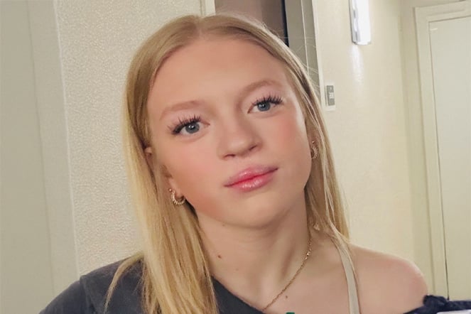 a young woman in a brightly lit hallway