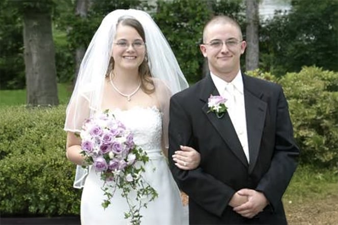 Julie in a wedding dress with Dan in a tuxedo.