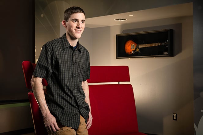 Daniel in teen room, guitar in background