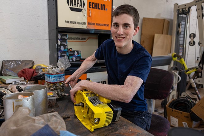 Daniel working with tools in workshop