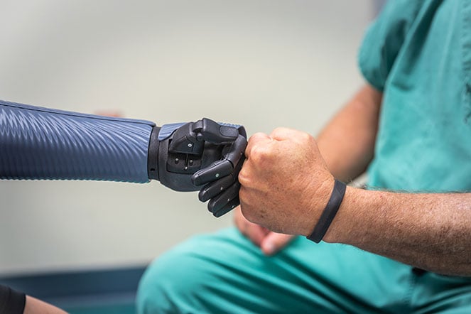 Danielle's bionic arm doing fist bump