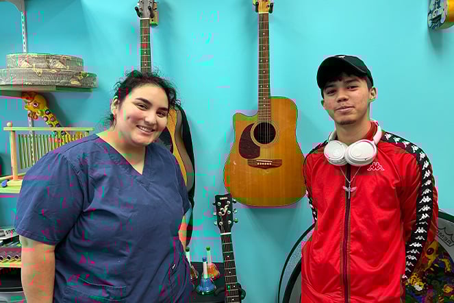 Elian with Shriners Children's Texas music therapist, Angie.