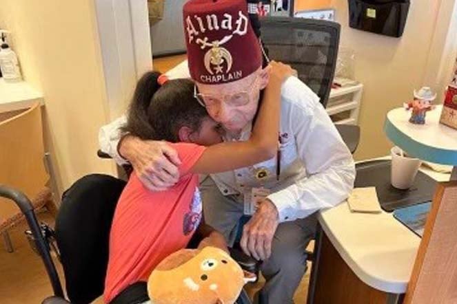 elizabeth hugging a shriner 