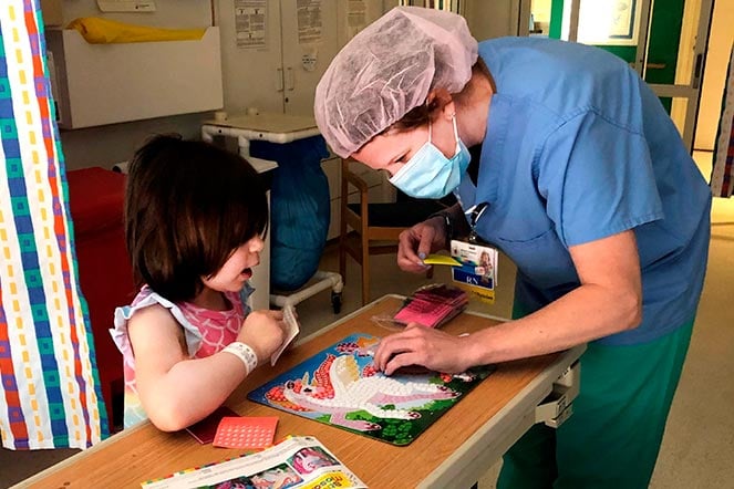 Child life provider working with Emily