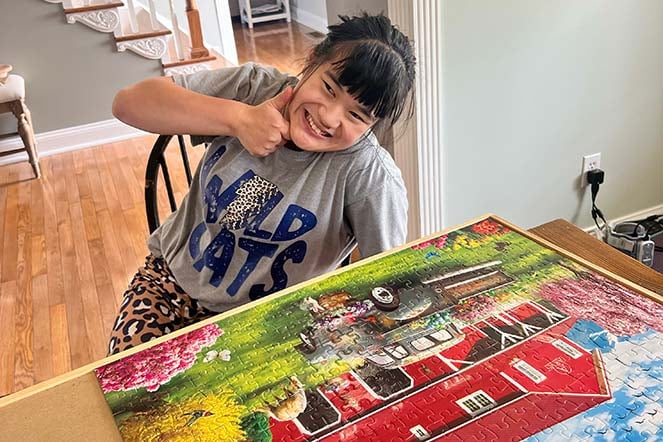 cerebral palsy patient Erica working on a puzzle