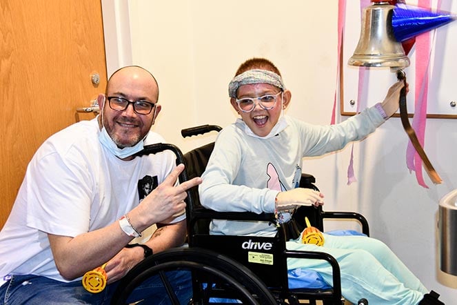Fabian with Dianelys as she rings the bell