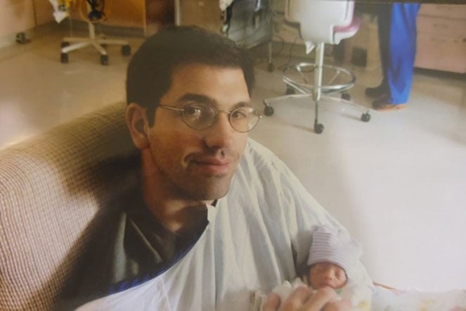 father holding infant daughter