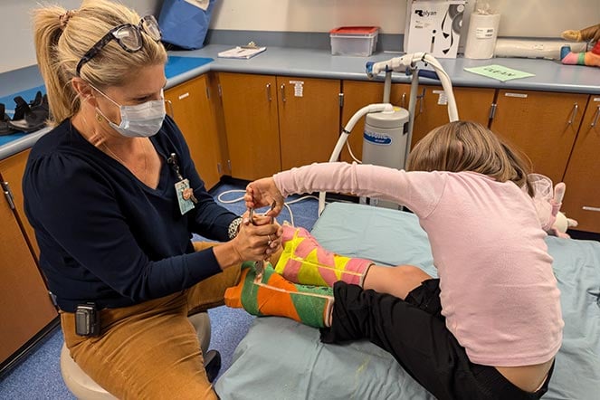 female patient and female provider remove leg casts together
