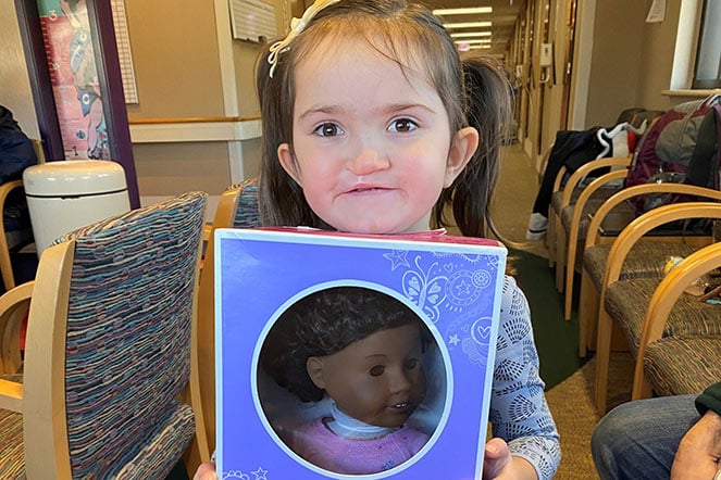 female patient holding toy