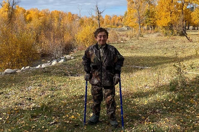 Gabriel in woods wearing camouflage clothing