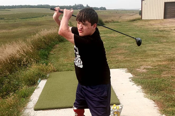 Gavin swinging golf club