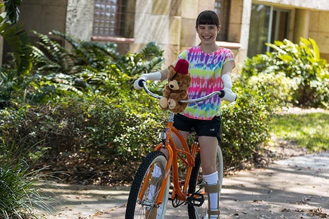 Grace riding adaptive bike wearing prosthetics