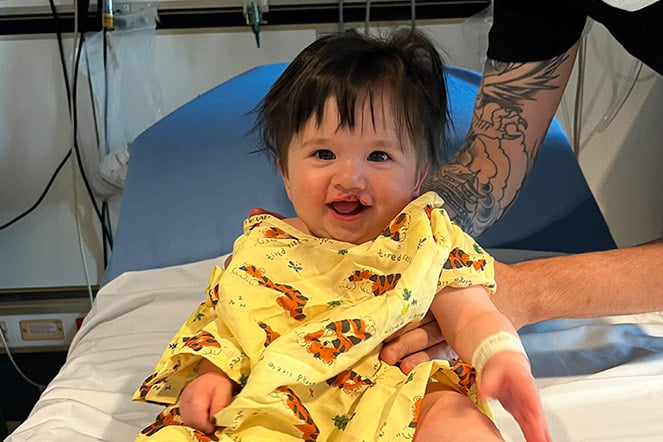 Jack sitting up in hospital bed smiling