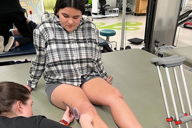 physical therapist working on jaadin's range of motion