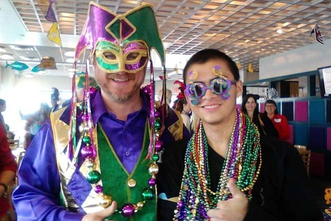 Juan Uriel and provider wearing mardi gras costumes