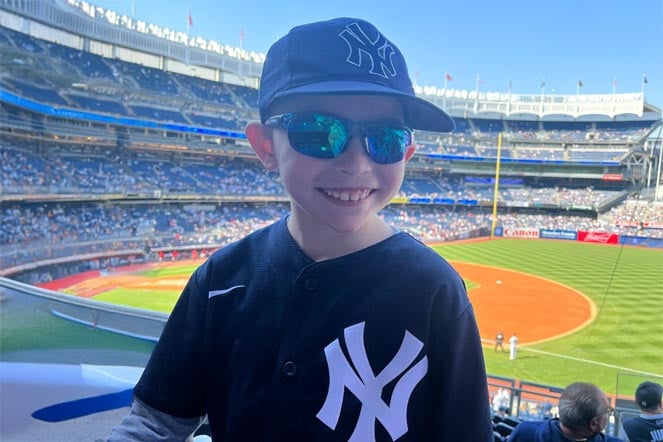 burn patient at baseball stadium wearing New York Yankees jersey