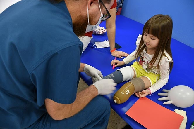 staff member working on karolinas prosthetic implant