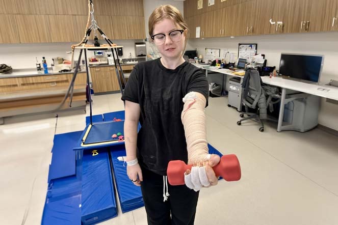 Kennedy lifting weights during therapy session