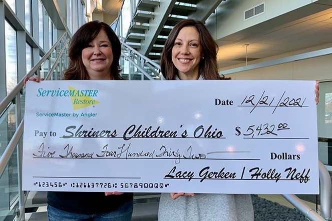 Lacy with donation check