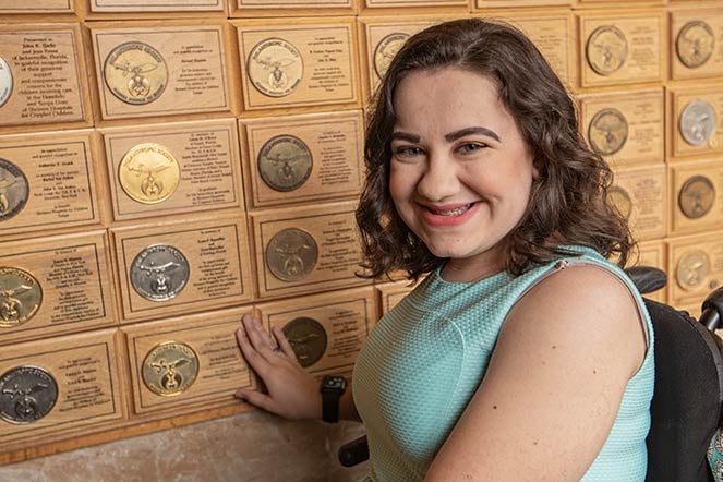 Leigh in front of Philanthropic Society Wall