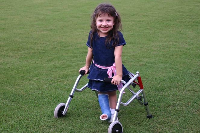 Leigh using walker at age 7