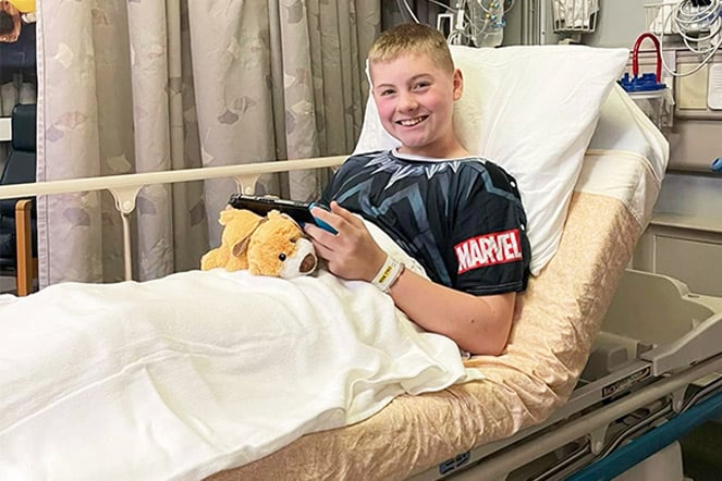 Patient playing video games in hospital bed