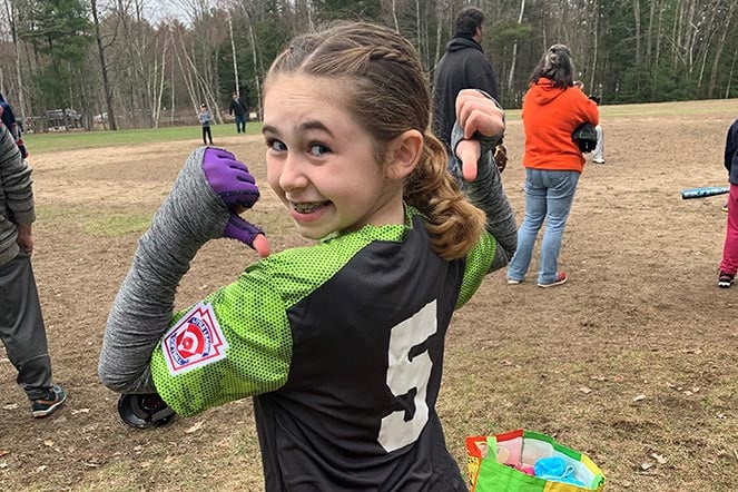 young Maddie on softball field