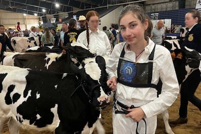 female scoliosis patient with her cow