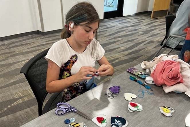 female scoliosis patient doing arts and crafts