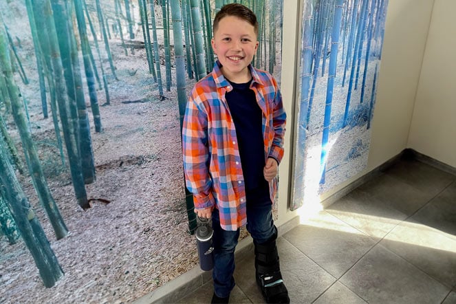 Andrew wearing walking boot