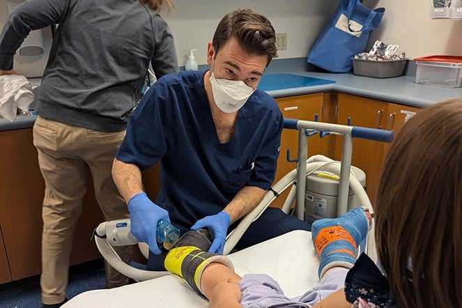 male provider removing leg cast