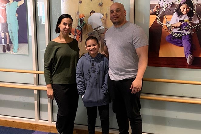 Mila with her mother and father