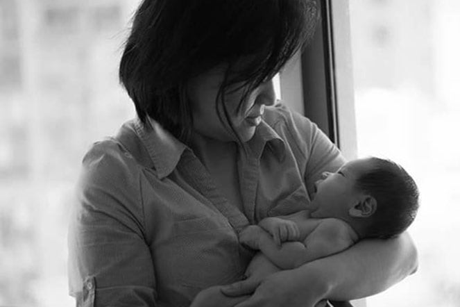 mother holding infant