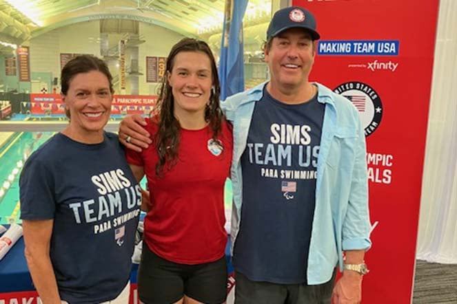 Natalie with mom and dad, wearing T-shirts that read "SIMS TEAM USA PARA SWIMMING"
